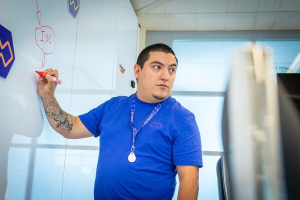 Principal Consultant of Booleans, Maurice Omar writing on a whiteboard